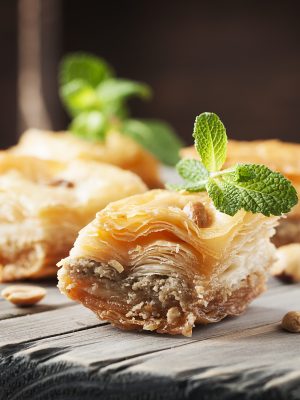 Traditional arabic dessert Baklava with honey, selective focus